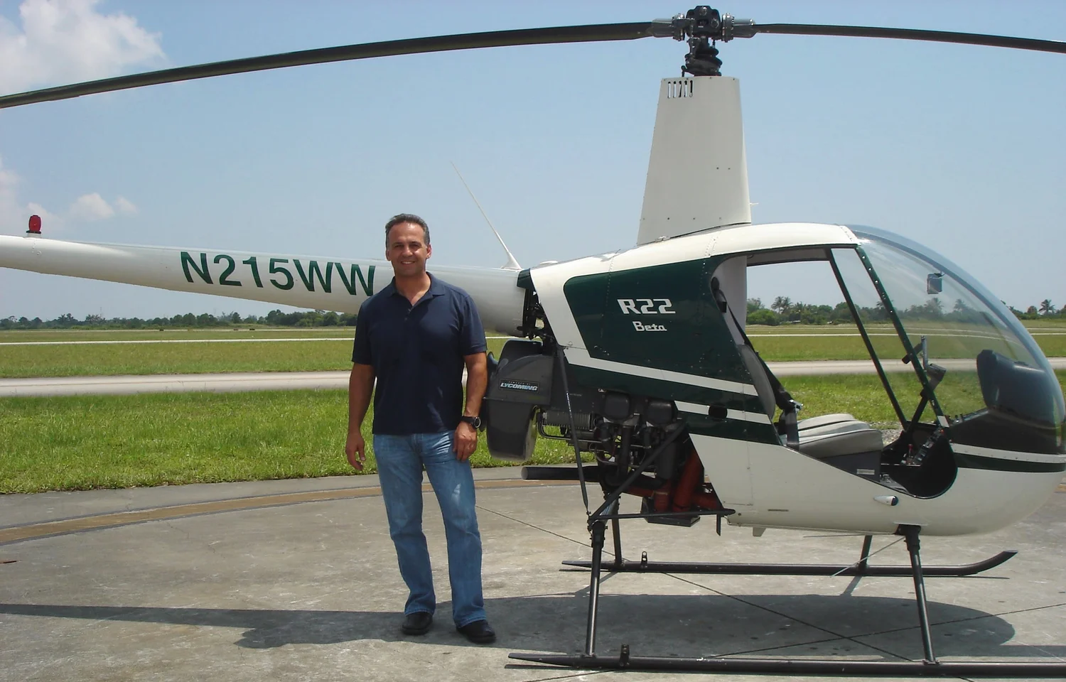 Ed Zakarian beside a Robinson R22 helicopter